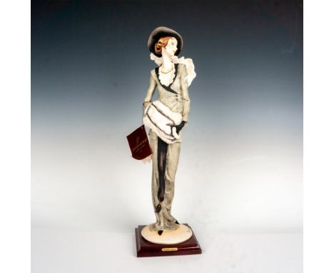 Limited edition featuring a lovely elegant woman with black and cream feathered headwear and coat with heels; attached wooden