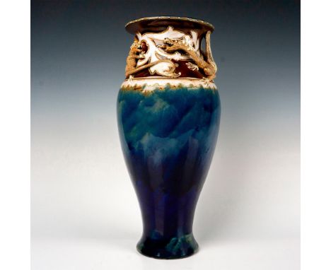 Incised stoneware, glazed blue; modeled in high-relief with a dragon and grotesque trailing round rim of vase. Impressed Roya