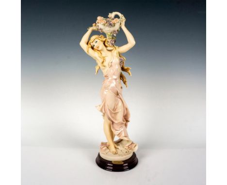Limited edition featuring a girl carrying a fruit and flower basket, standing on a round wooden base. Giuseppe Armani signatu