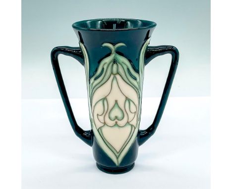 Dark green twin handled vase with a stylized Art Nouveau white flower. Moorcroft marked. Artist's marking on the base. Artist