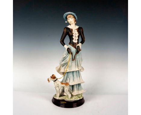 Limited edition featuring a lady taking a afternoon stroll with her dog; standing on a round base. Giuseppe Armani signature 