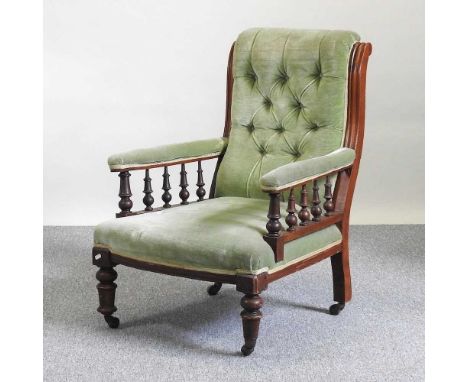 A Victorian green upholstered button back open armchair, on turned legs