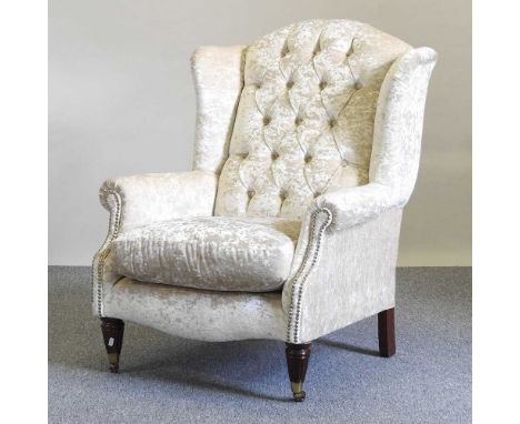A modern cream upholstered button back armchair, on turned legsDirt under the cushion from use. Overwise some very light sign