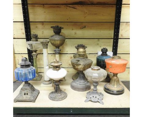 A collection of ten various oil lamp bases and parts, highest 48cm (10)