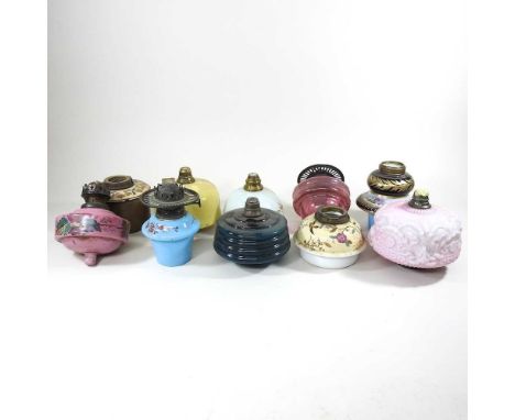A collection of ten various oil lamp fonts, to include Doulton (10)