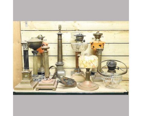 A collection of ten various oil lamps, tallest 56cm, together with a brass wall light (11)