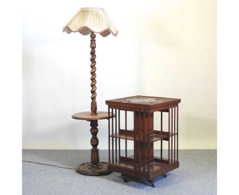 An Edwardian revolving bookcase, together with a 1930's spirally turned oak oak standard lamp (2)53w x 53d x 81h cm