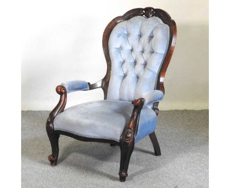 A Victorian walnut and blue upholstered button back armchair