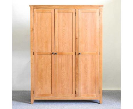 A modern light oak triple wardrobe, enclosed by panelled doors142w x 55d x 190h cm