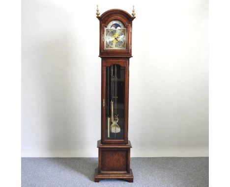 A modern oak cased longcase clock, by Interclock, having a brass dial with moonphase, the three train movement striking on go