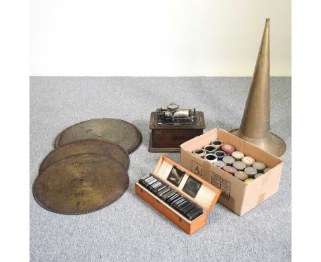 An Edison phonograph, 32cm, together with a collection of wax cylinders, symphonium discs, a brass horn and magic lantern sli