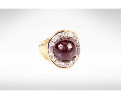 A Georgian Garnet and Diamond mourning ring. Central round cabochon cut garnet approximately 11mm diameter with a surround of