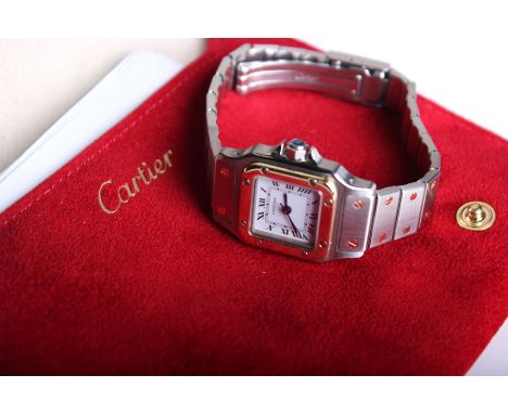A Cartier Santos Ladies bi coloured metal wristwatch. White enamel square face with Roman numeral markers and faceted sapphir