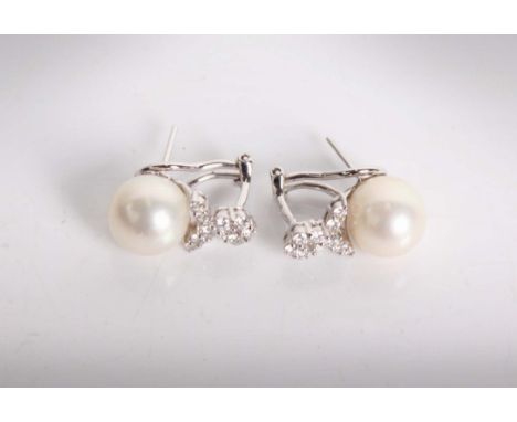 A pair of 18ct white gold pearl and diamond ear studs. 10mm full cultured pearls each set with 10 brilliant cut diamonds in a
