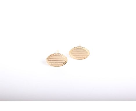 A pair of 9ct gold cuff links with engine turned decoration. 6.3g 