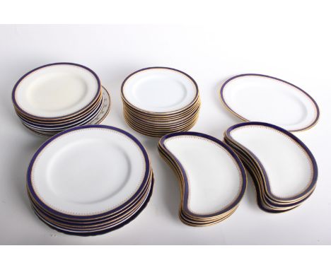 A quantity of Spode and Royal Worcester blue and gilt rim dinner ware, to include crescent-shaped side plates, together with 