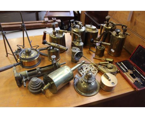 A pine tool box with a painted interior containing a quantity of brass oil cans, recording clock, candle sconces and further 