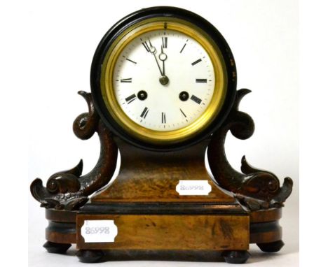 A Victorian striking mantel clock, enamel Roman dial, twin-train movement, carved dolphin supports on a plinth base