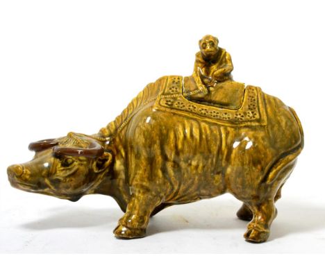 A Chinese brown glazed model of a water buffalo, a monkey astride its cover, 19th century 