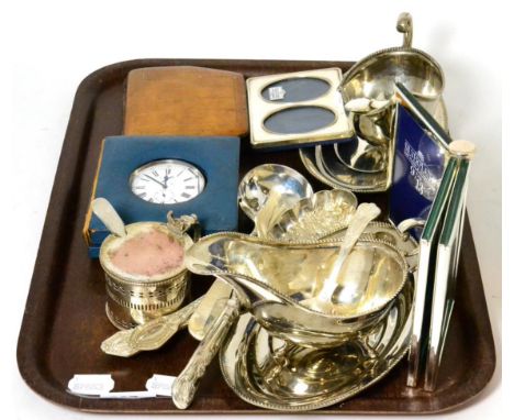 A group of silver plated items, a small silver photo frame; a pocket chronometer; an Art Deco bedside travelling timepiece et