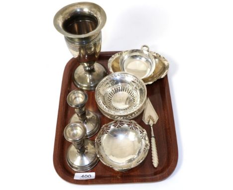 A silver wine taster with serpent handle; a silver vase; a pair of pierced dishes; two other small dishes; a pair of candlest