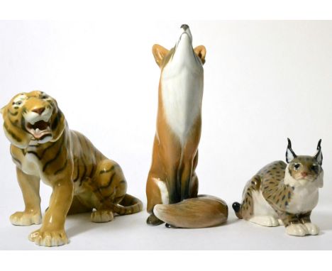 A large Royal Copenhagen model of a seated fox; another of a lynx; and a Bing & Grondahl model of a tigerAll in good conditio