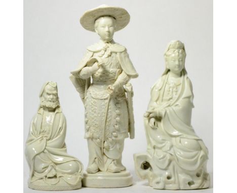 A Chinese blanc-de-chine figure of a young warrior, 19th century, a seated Guanyin with scroll, and a figure of a seated bear