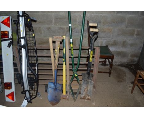 A quantity of tools to include a post hole digger; large mallet; a pick axe etc