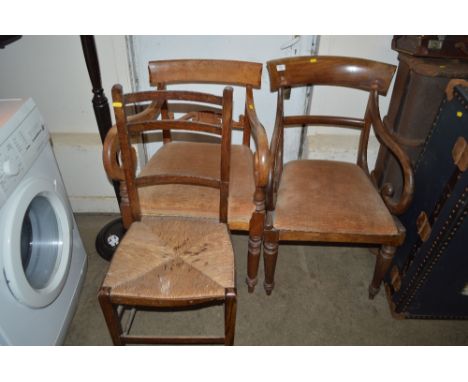 Two Victorian mahogany elbow chairs together with a ladder back chair