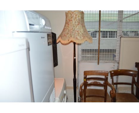 A mahogany lamp standard and shade