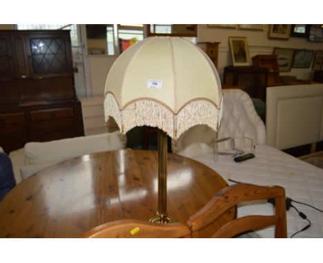 A decorative brass table lamp and shade
