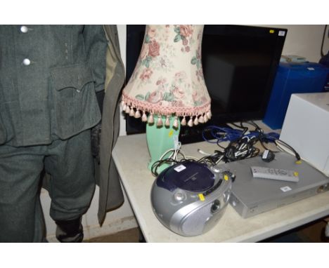 A Philips CD player together with a table lamp and floral shade