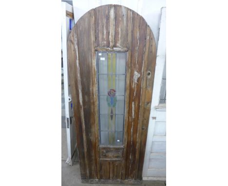 An Arts and Crafts pine and stained glass door 