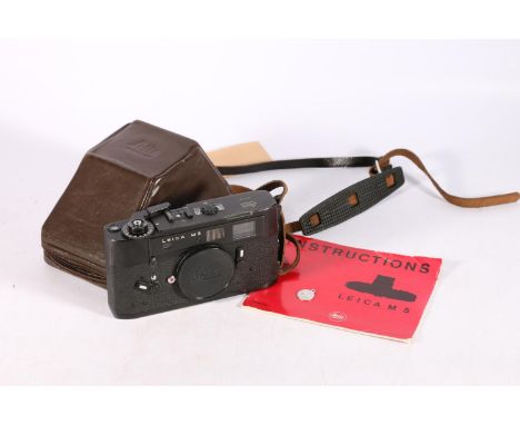 Ernst Leitz Wetzlar Leica M5 camera body, serial number 1287744, in a Leica trapezoidal prism shaped brown leather case  The 