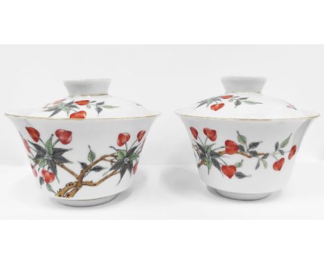 CHINESE REPUBLIC LIDDED PORCELAIN TEACUPS AND SAUCERS, a pair, with foliate polychrome enamel decoration and red seal mark to