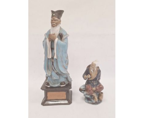 Chinese tinted bisque and partly glazed figure of a sage in blue robes and on square ceramic plinth base, 42cm high and anoth