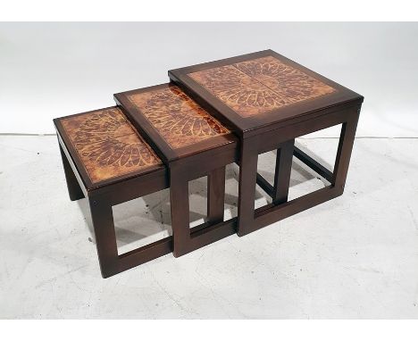 Mid-century nest of three tables with tile tops, flowerhead design to the centre 