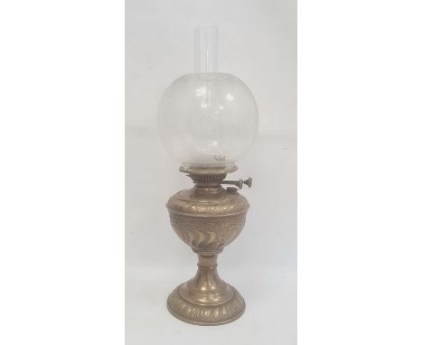 Brass and glass oil lamp with scroll decorated well, on circular foot and the etched bulbous shade and chimney 