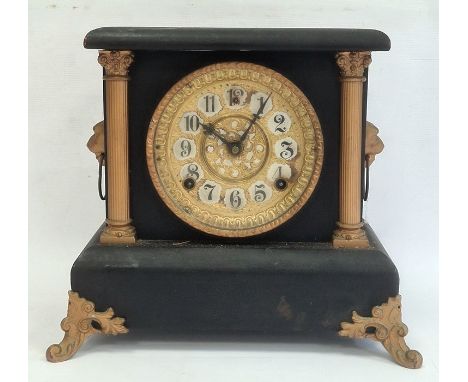 Mantel clock with arabic numerals, painted black body and gold painted highlights, chiming mechanism, verso marked WML Gilber