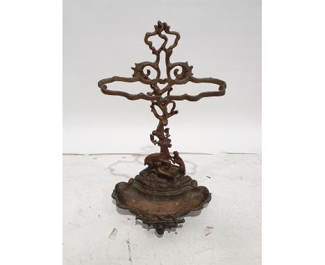 Victorian cast iron stickstand, the back formed as hound and stag, the drip tray surmounted by riding crop and hat, 70cm tall