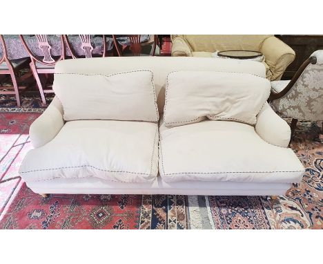 Modern armchair and two seat sofa in the manner of Howard and possibly by George Smith, in cream ground upholstery, shaped si