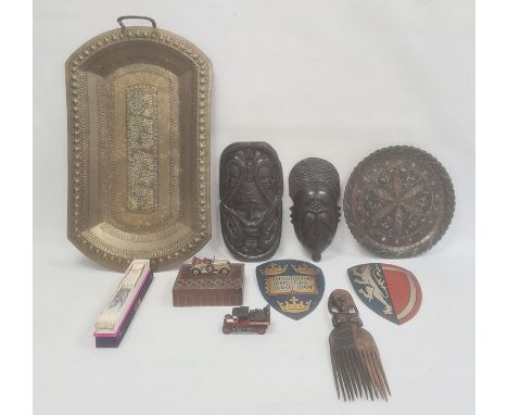 African carved ebony mask comb, an Eastern brass tray, two painted metal shield wall plaques and other collectable items 