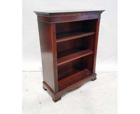 20th century mahogany open bookcase, the rectangular top with ogee moulded cornice, fluted pilasters, three shelves, on brack