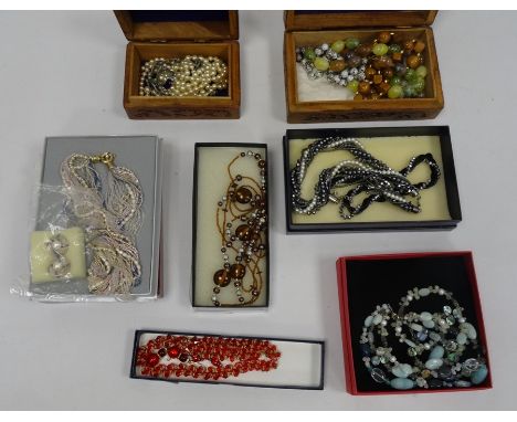 Carved hardwood box and contents including cloisonne enamel beads and other items of costume jewellery including hardstone be