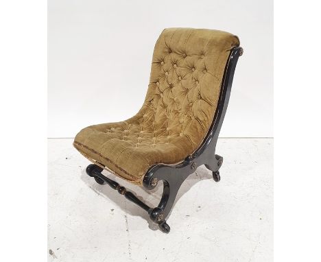 Late Victorian low chair in olive green button upholstery, black ebonised frame, raised on black china castors 