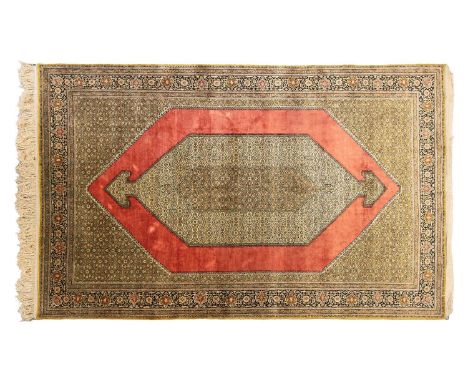 A North Persian style silk on silk Qum carpet, with double barbed lozenge on a tomato red field within multiple borders, 323 