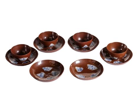 A set of four Chinese Qianlong, Batavian ware tea bowls and saucers with resist panels painted with blue and white decoration