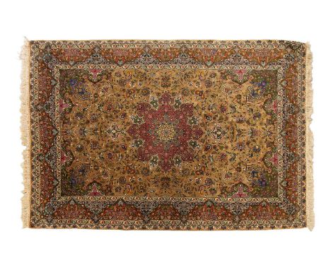 An old finely woven golden ground Isfahan rug, with a central polylobate medallion on a field of swirling Islimi, within mult