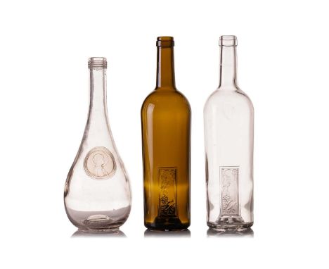 Two Lalique wine bottles, in clear and green glass, each marked 'Femme et Raisins Rene Lalique', with inset panel depicting a
