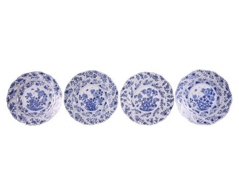 A set of four Chinese Kangxi blue and white porcelain moulded "silver-shaped" plates, the soles painted with flowering shrubs